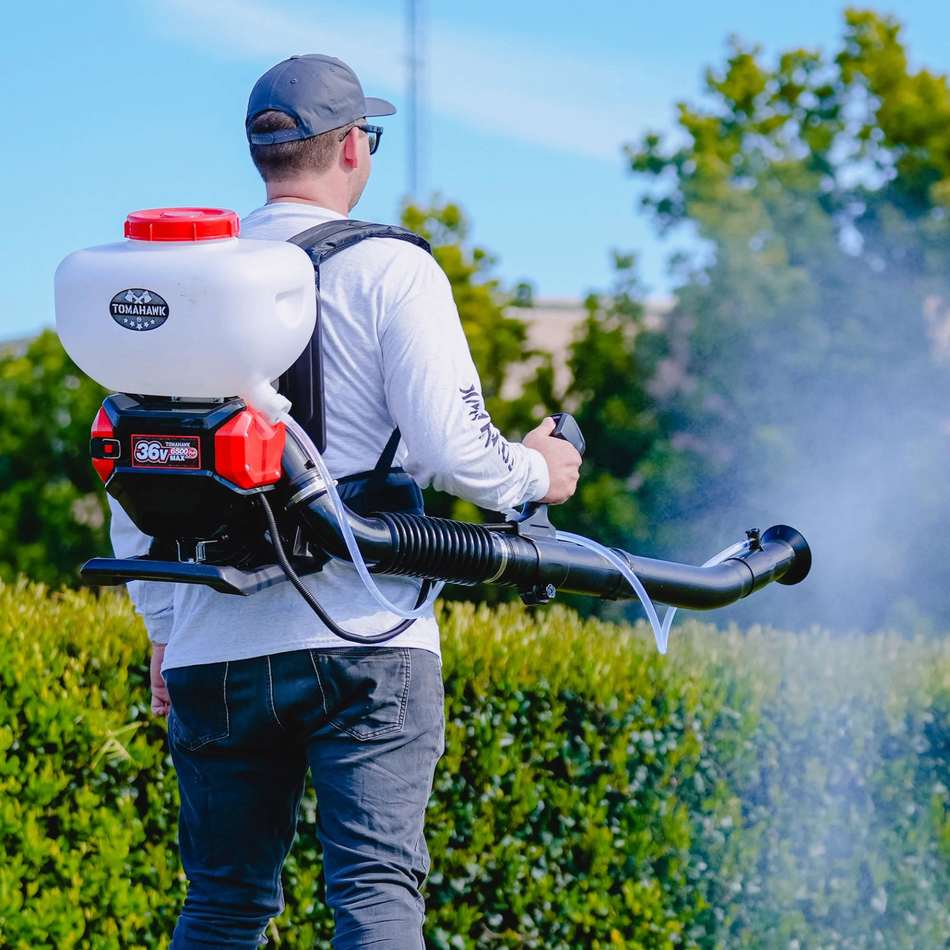 Technician applying all-natural mosquito and tick barrier spray